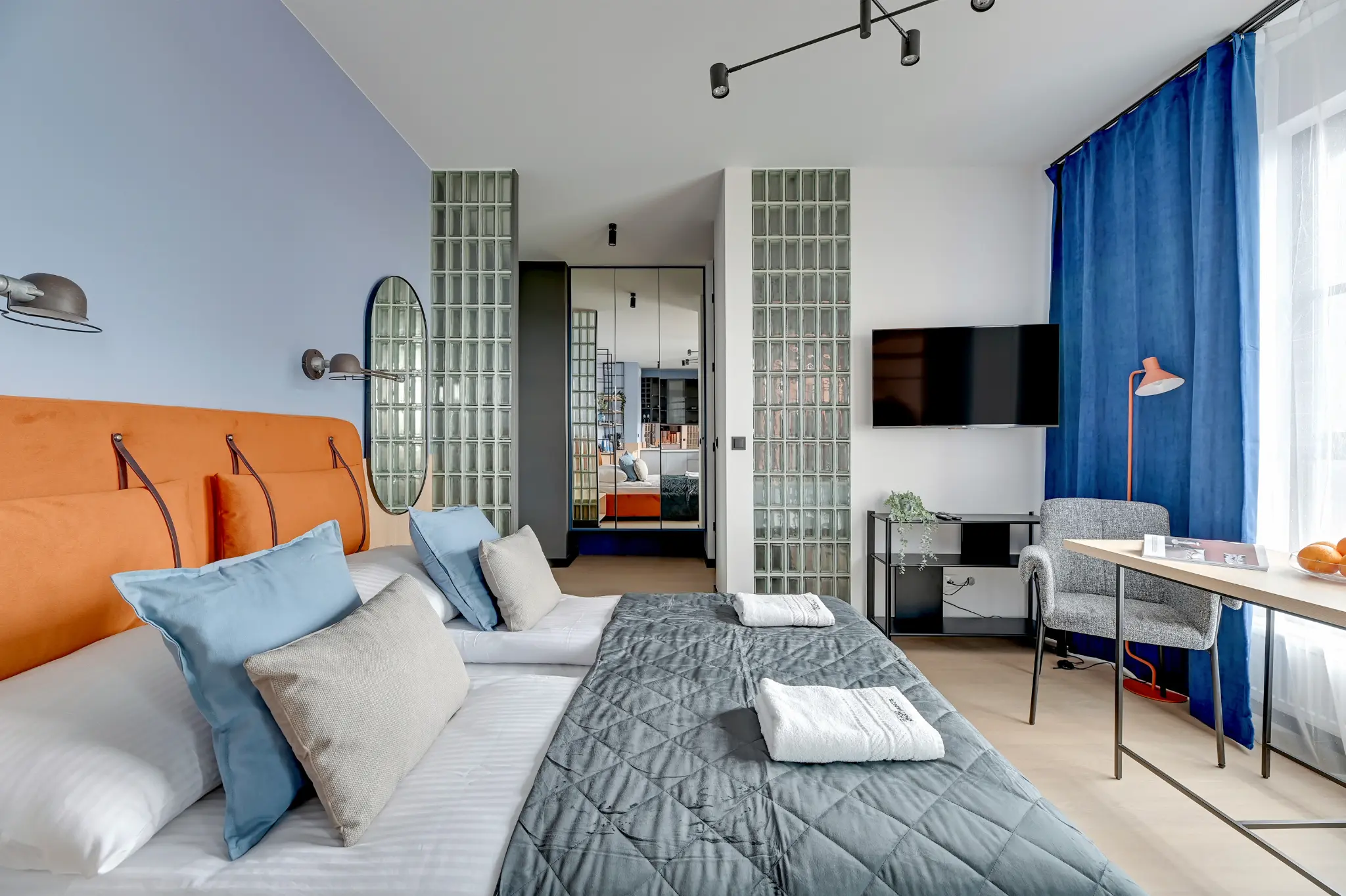 Łóżko, stół i zasłony w apartamencie DOKI
