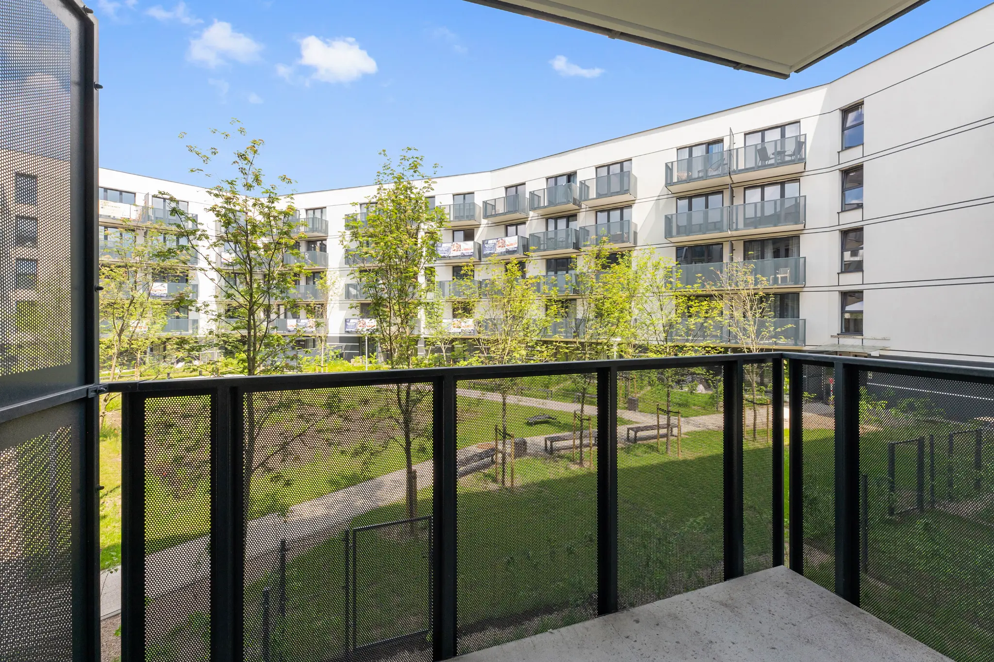 View from a balcony of Murapol Portovo buildings and greenery in Gdańsk