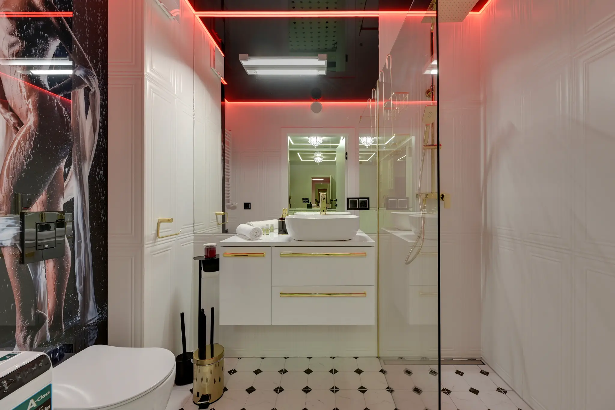 Bathroom with a mirror, shower and coloured lighting in an apartment in Portovo