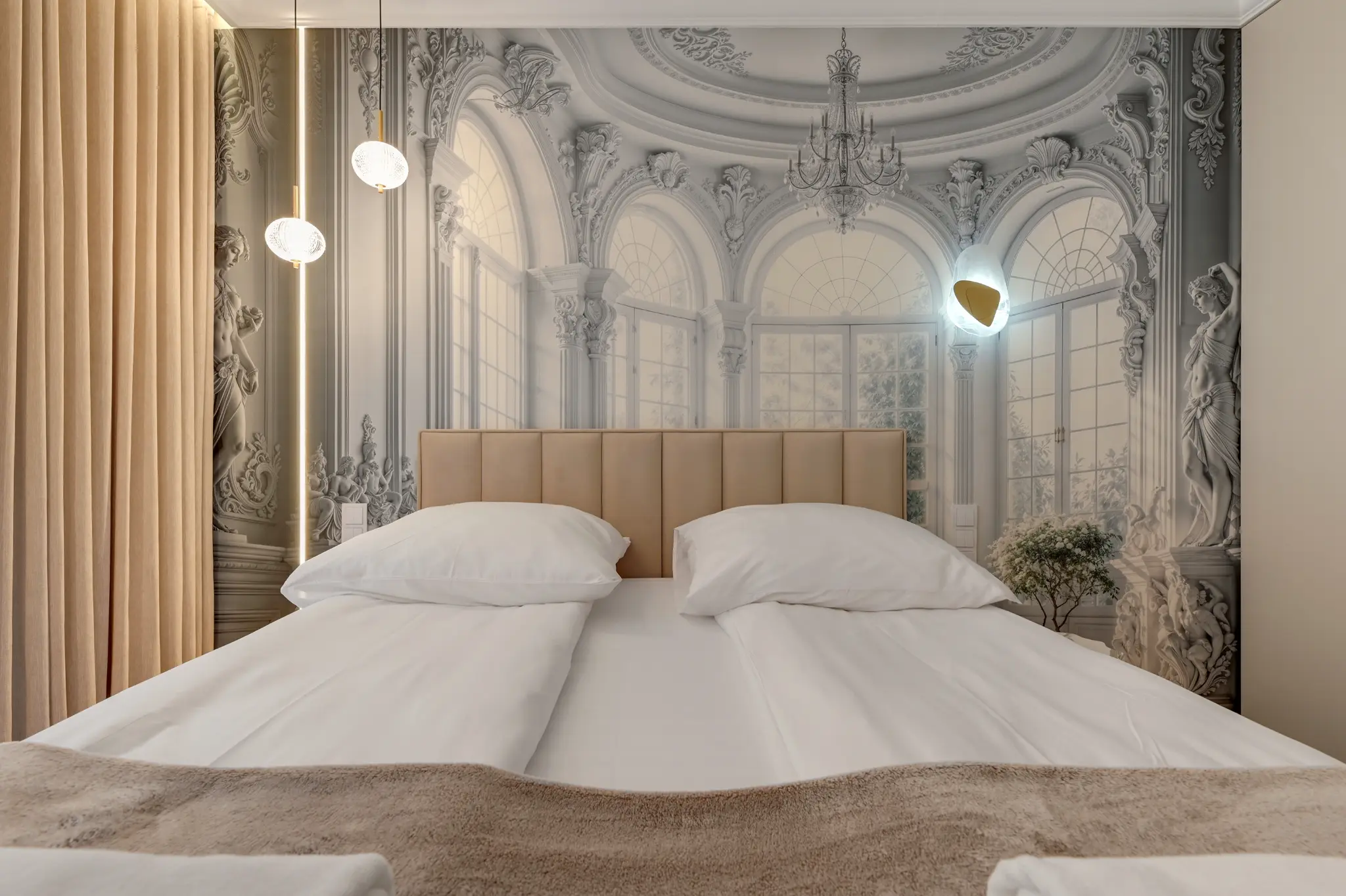 Bed with light-coloured linens and a decorative wall in a bedroom at Mostek