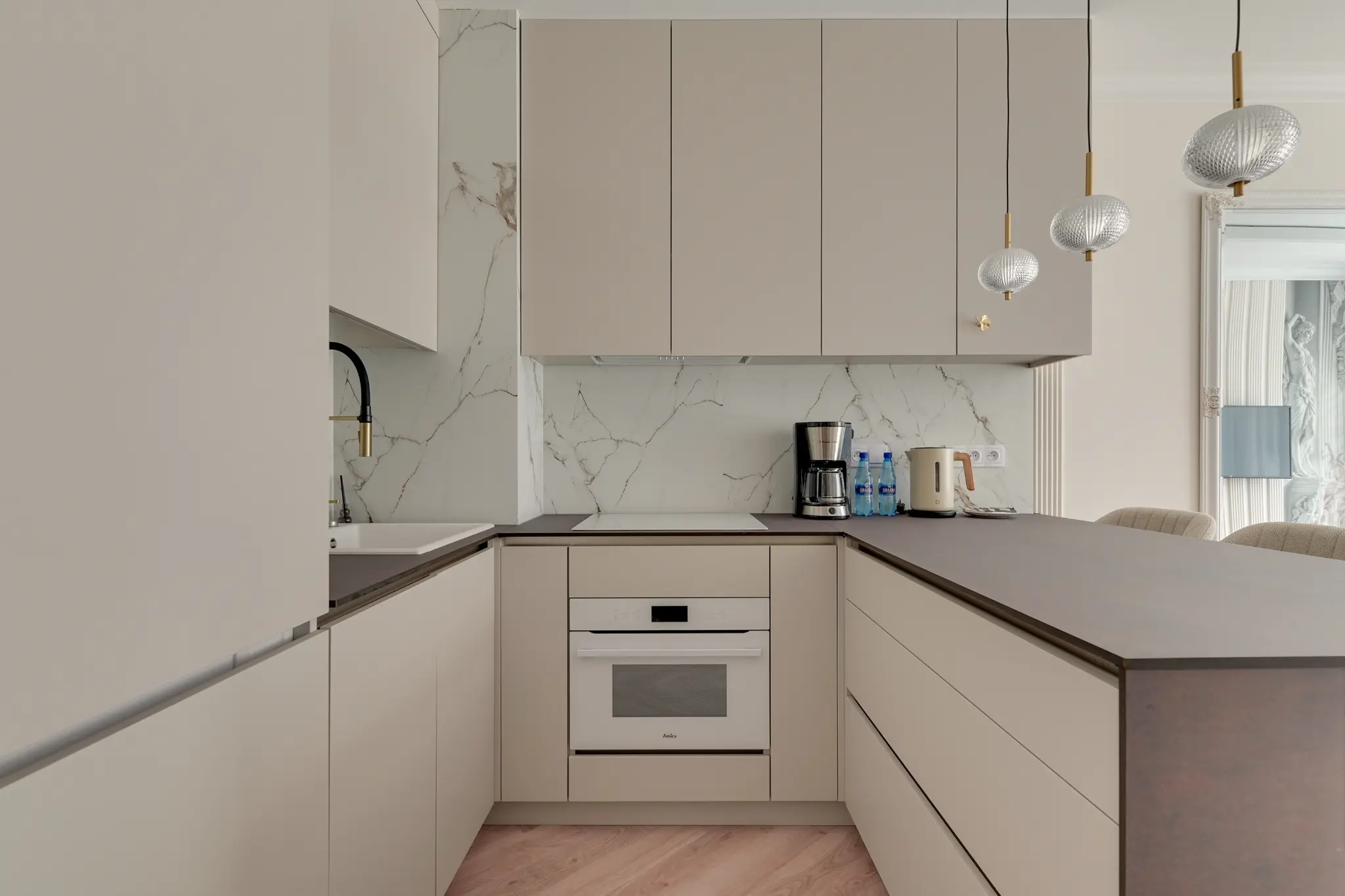 Bright kitchen with a worktop and equipment in an apartment on Mostek Street
