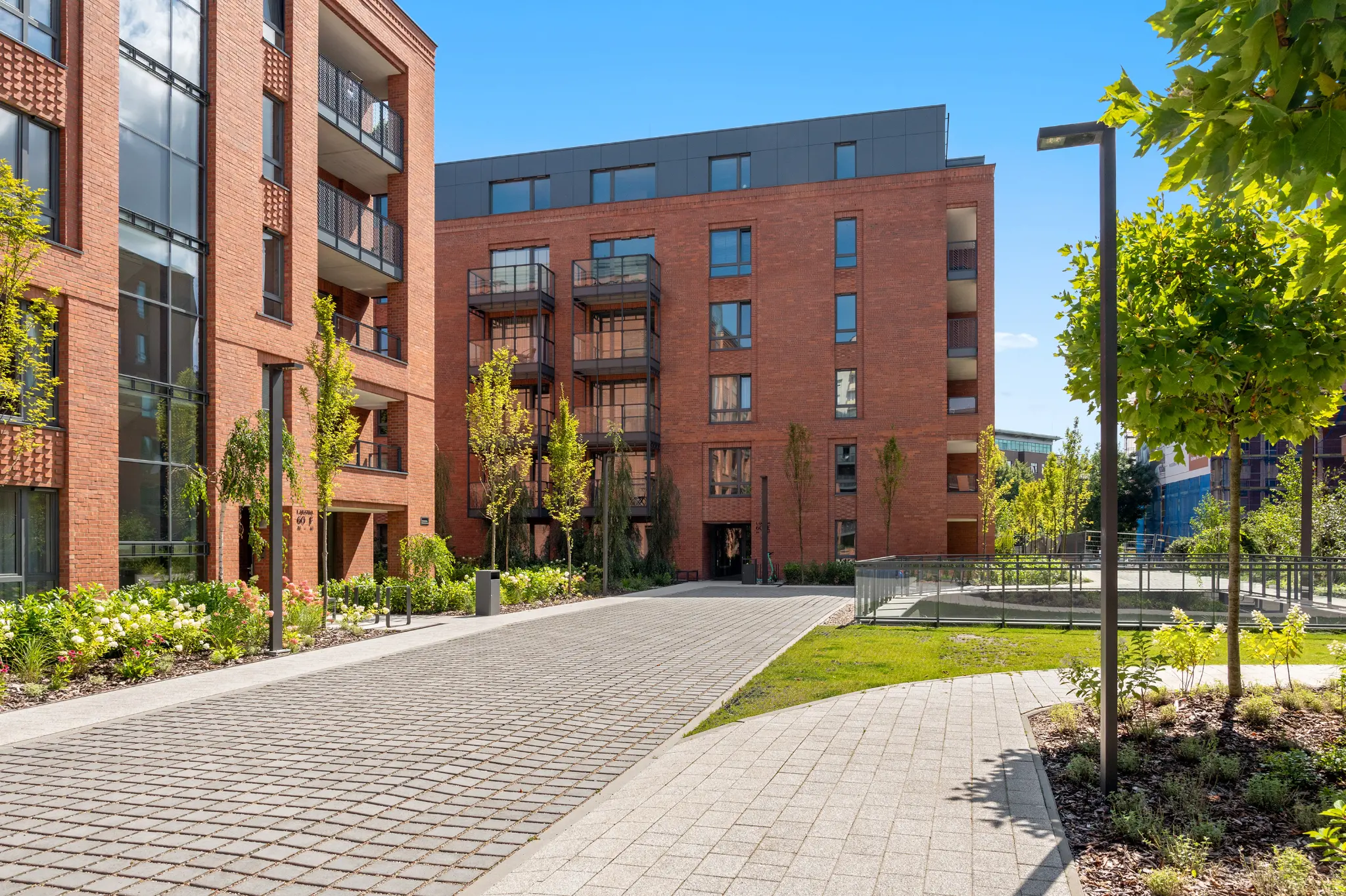 Scala in Gdańsk — a courtyard with walkways and greenery between brick buildings with balconies