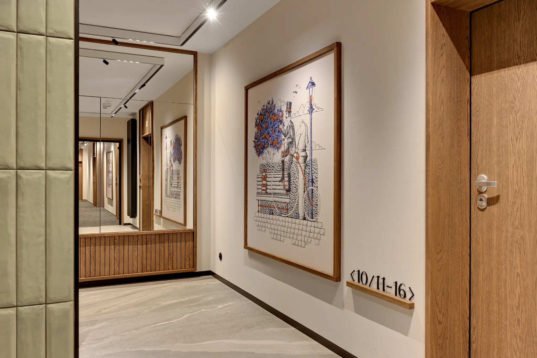 Corridor in the Scala building — wooden doors, a large mirror, vertical slats and track lighting