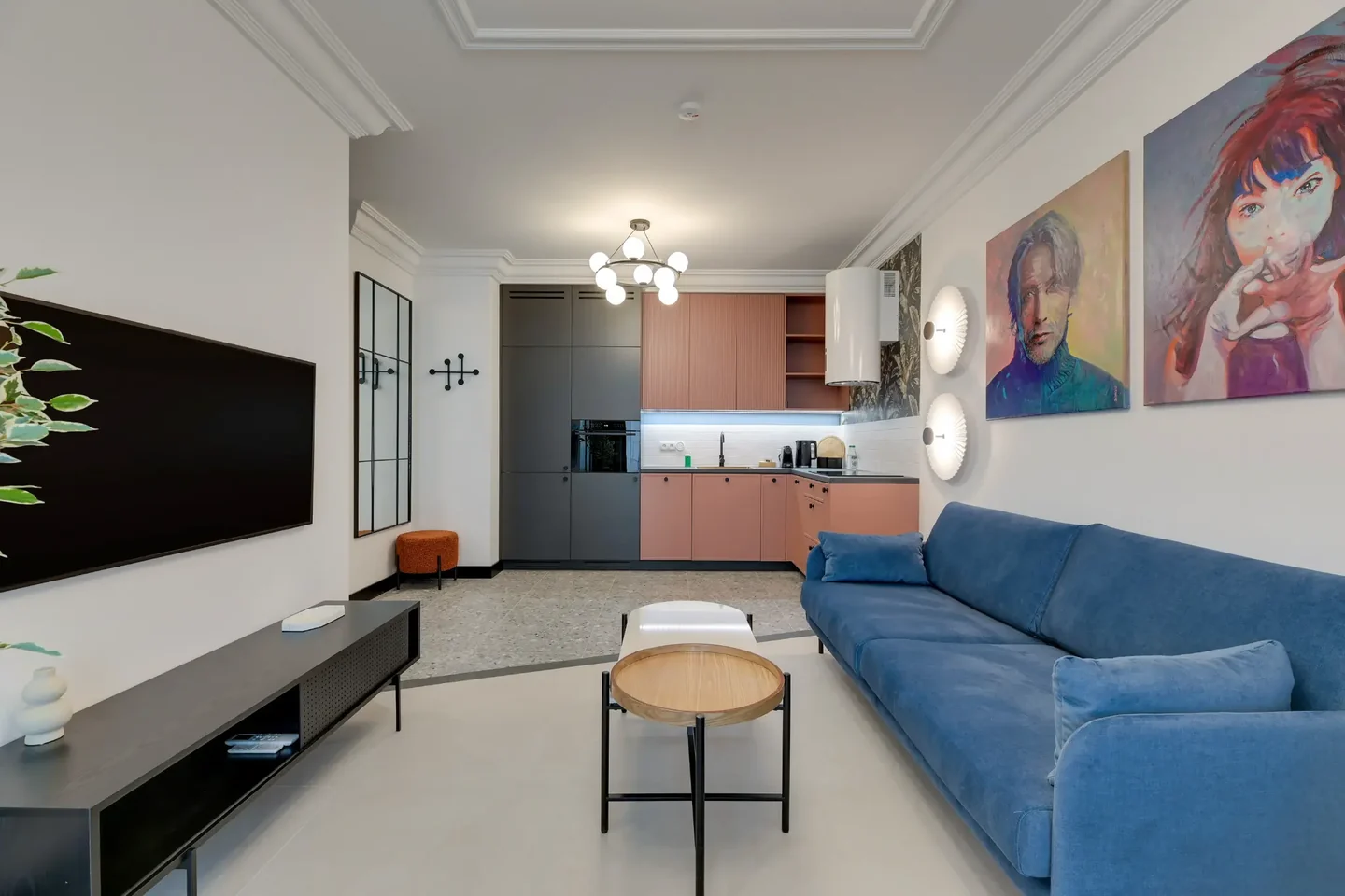 Living room with a kitchenette in an apartment offered by GrandRent.